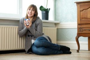 Woman enjoying the warm air inside her home