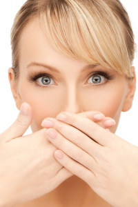Woman covering mouth and nose