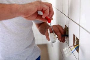 Electrician installing wall outlets